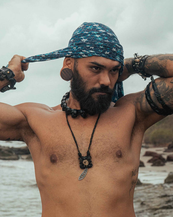 Man wearing Realm of Metatron bamboo scarf with sacred geometry print styled as a head wrap