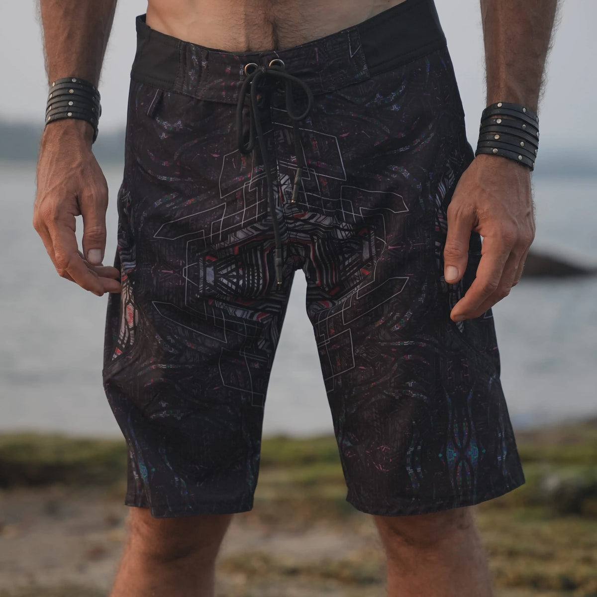 Star Dust psychedelic board shorts for men with a dark geometric print and adjustable drawstring waistband