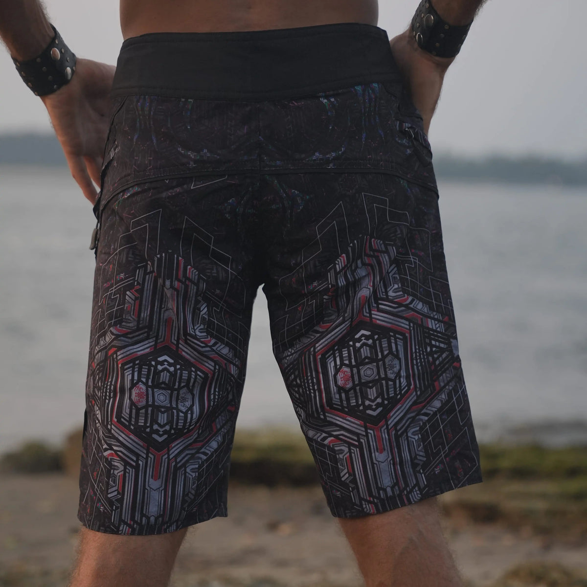 Rear three-quarter view of Star Dust men's printed board shorts showing the geometric pattern and longer cut