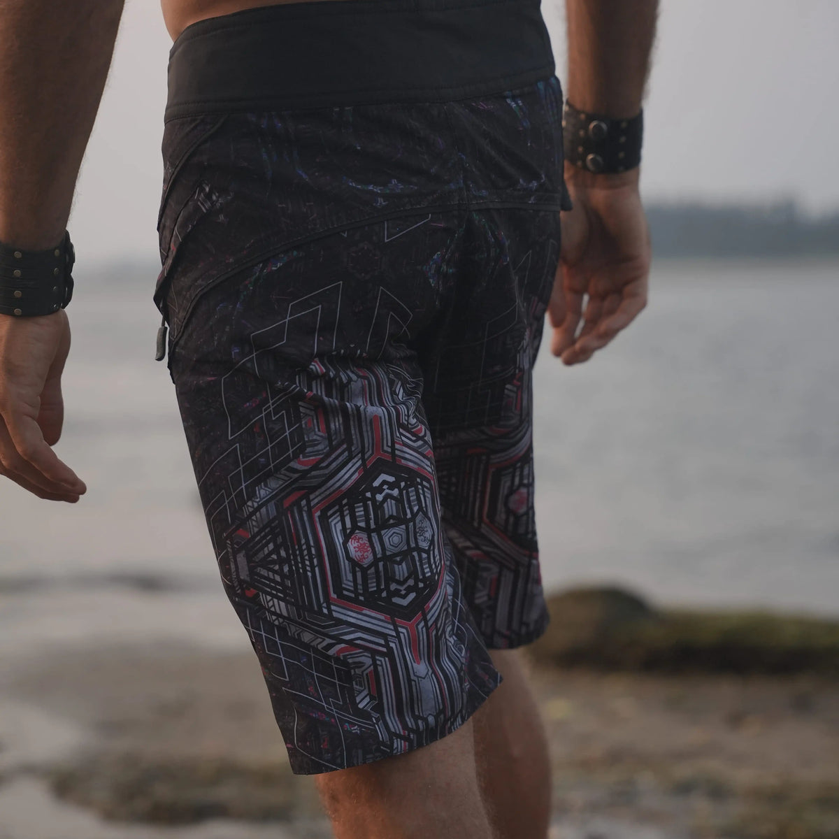 Back view of Star Dust psychedelic board shorts for men with dark geometric print and contrasting waistband