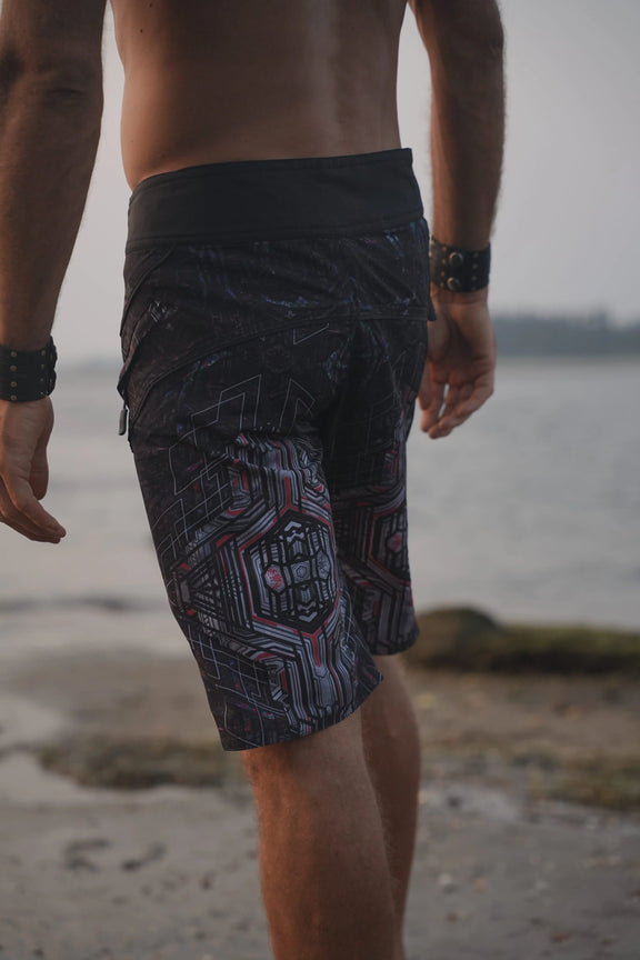 Back view of Star Dust psychedelic board shorts for men with dark geometric print and contrasting waistband