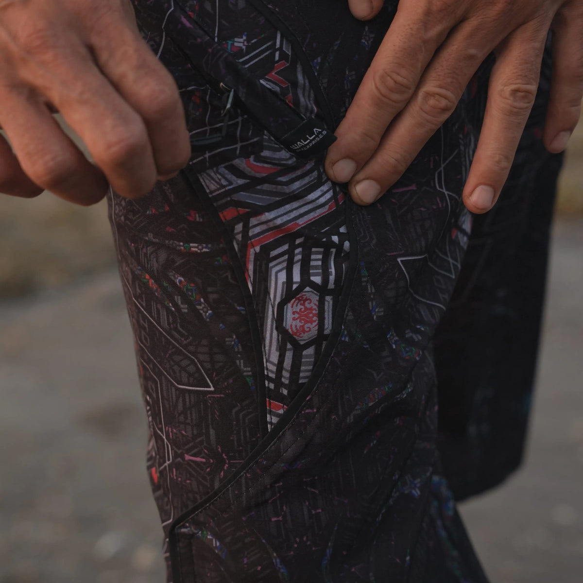 Close-up of Star Dust men's board shorts showing the dark geometric print and drawstring waistband