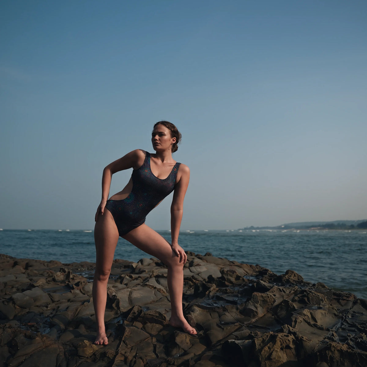 one piece cut out swimsuit full body shot transcendental psychedelic design seaside rocks