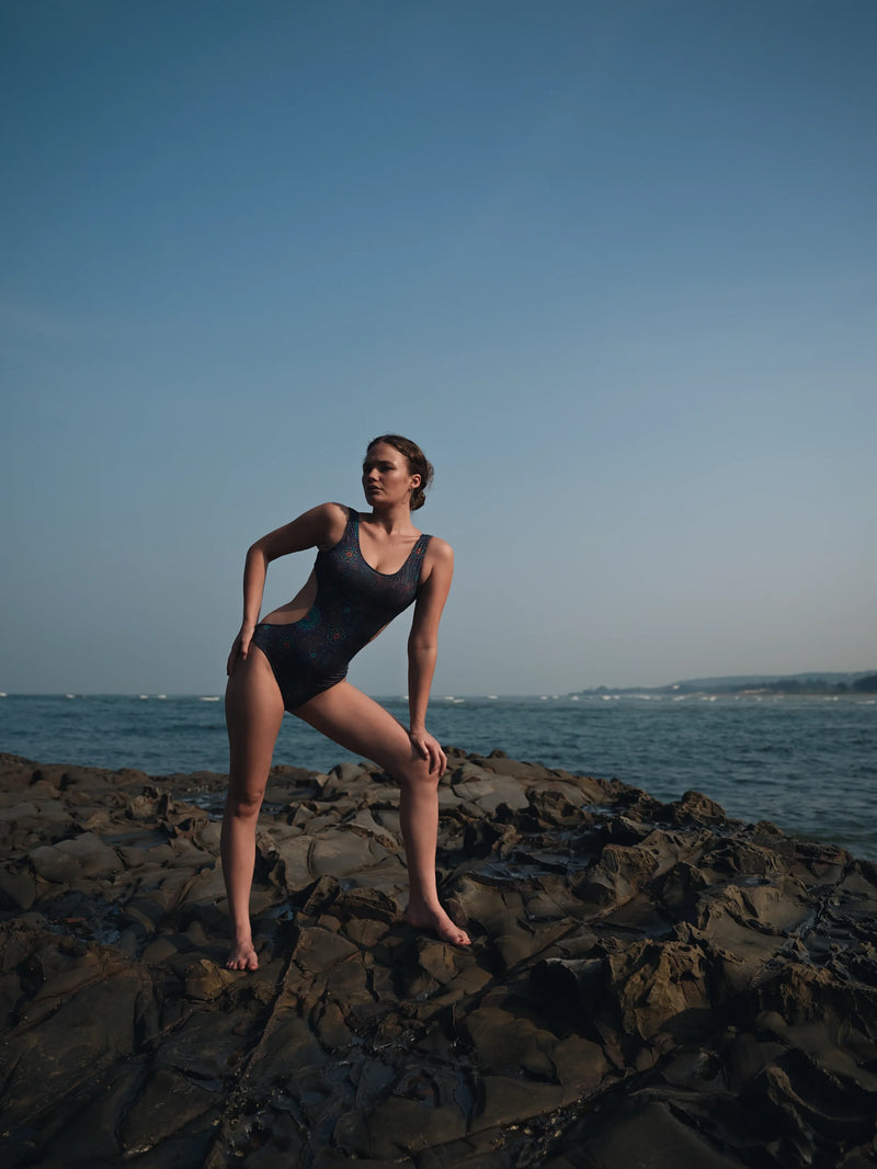 one piece cut out swimsuit full body shot transcendental psychedelic design seaside rocks