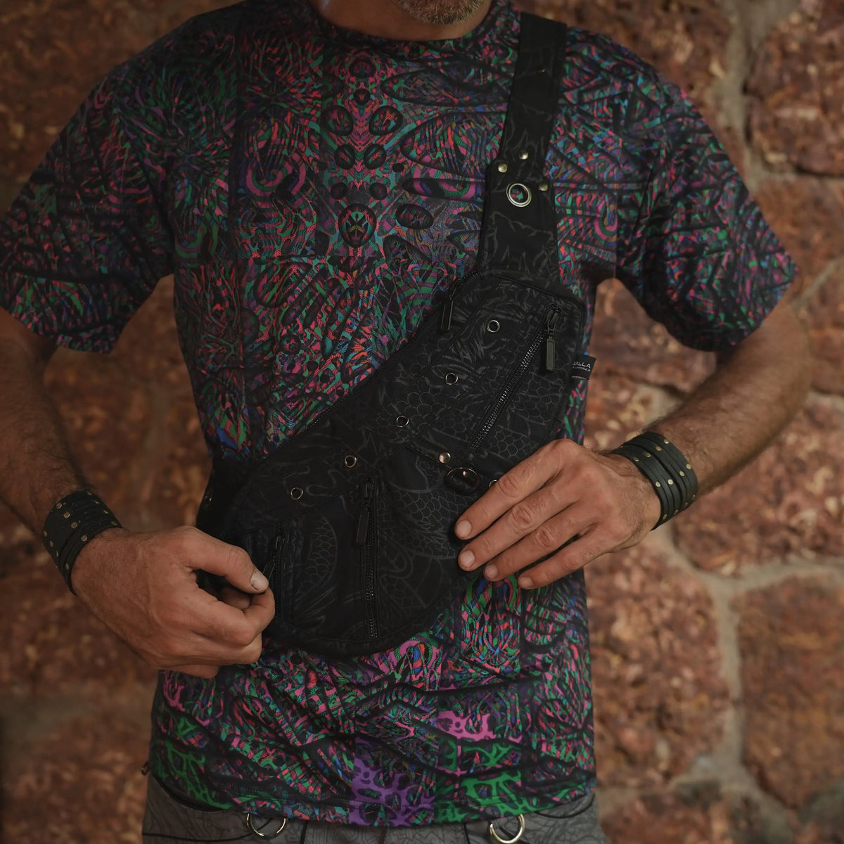 Vanta Dragon crossbody bag worn at the front, showing its compartment layout and adjustable strap