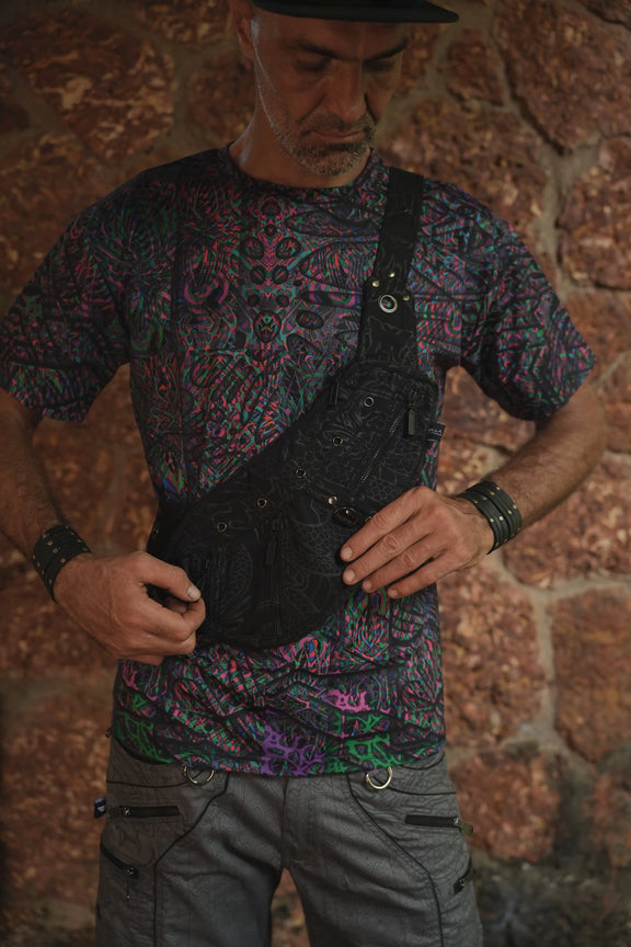 Vanta Dragon crossbody bag worn at the front, showing its compartment layout and adjustable strap