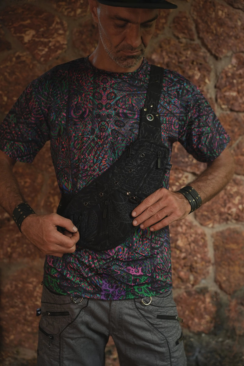 Vanta Dragon crossbody bag worn at the front, showing its compartment layout and adjustable strap