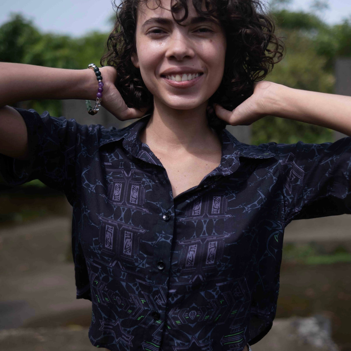 Close-up of Xenomorph bamboo cropped shirt showing abstract purple and orange pattern