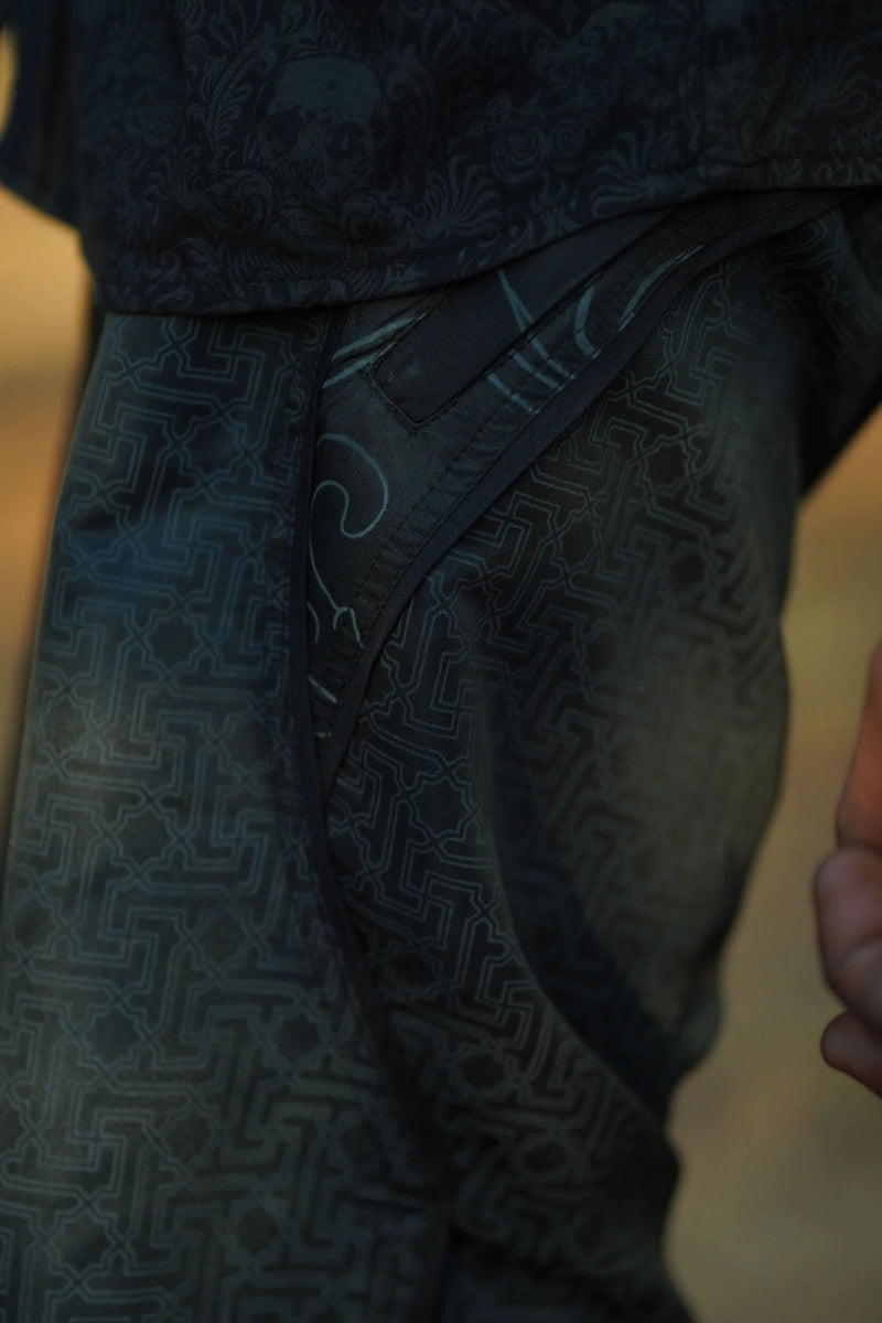 black festival swim shorts with geometric pattern pocket detail