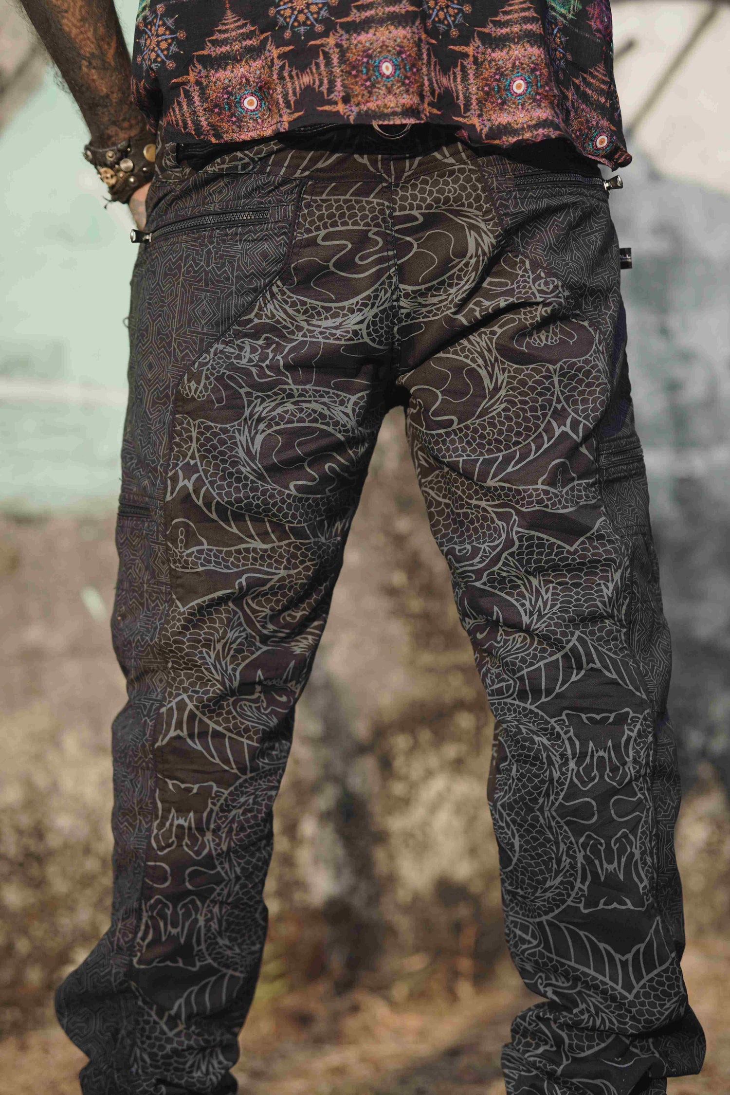 stretchable black cargo pants men with tribal and dragon-inspired pattern
