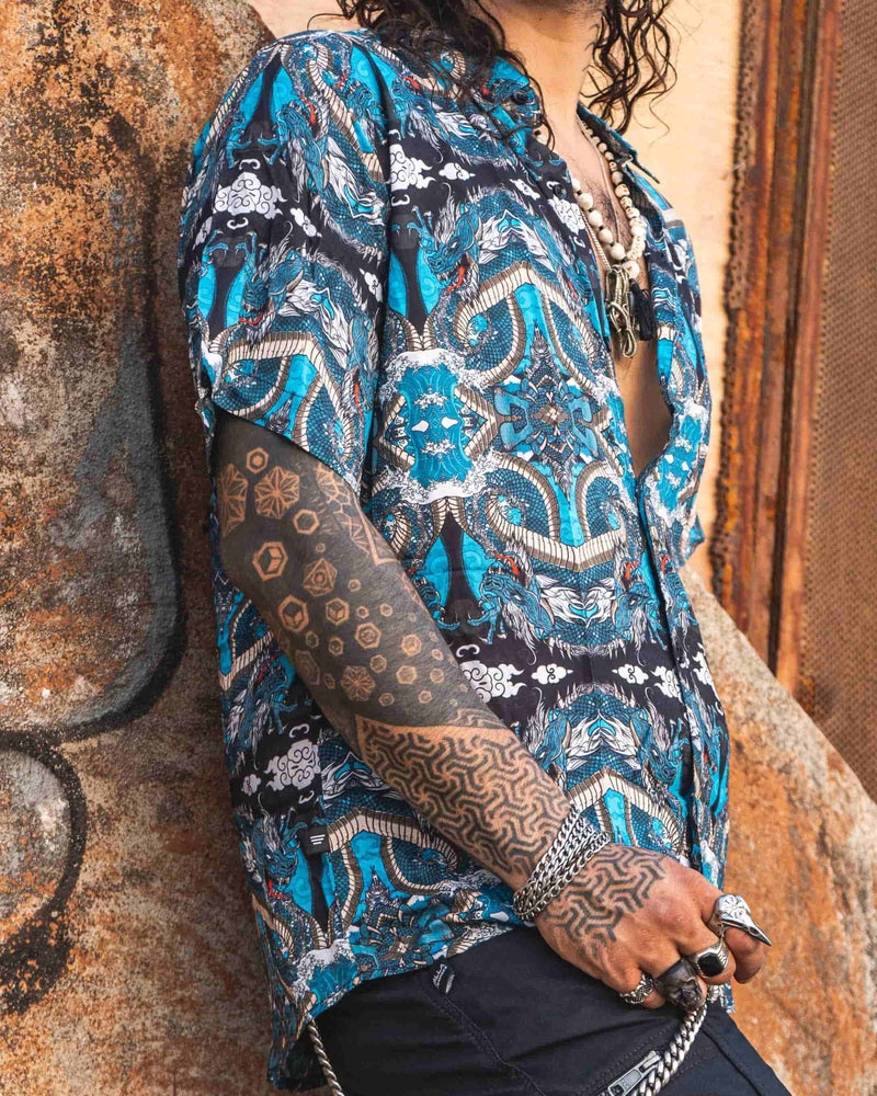 Men's bamboo shirt with artistic dragon prints in neon blue and black tones, crafted from eco-conscious bamboo fabric.