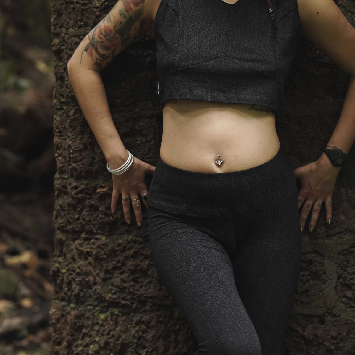 Woman wearing Magma Codex black screen-printed cotton lycra leggings